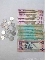 Full lot layout of UAE coins and banknotes showing denominations.