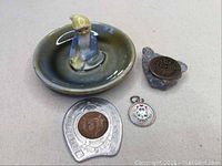 Full lot overview with porcelain dish, horseshoe penny token, Blarney Luckstone, and sterling charm
