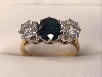 Front view showing central sapphire and side diamonds