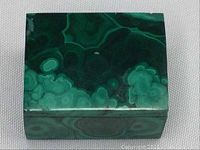 Top view of the rectangular malachite stone trinket box showing natural swirled green banding pattern.