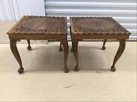 Pair of vintage carved wood side tables seen from front and side showing general shape and condition