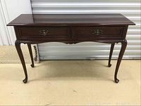 Front view of mahogany sofa table showing two drawers and cabriole legs