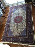 Full view of rug showing central medallion, field and borders