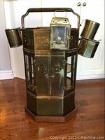 Front view of brass and glass cart with four condensers and lantern attached