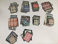 Overhead image of multiple Canadian stamp blocks arranged on display sheets, showing diverse designs and colors from 1953 to early 1960s.
