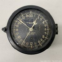 Front view of clock face showing 24-hour dial and radial cracks in glass