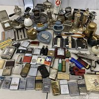 Overview of entire lot showing lighters, cases, trays and accessories
