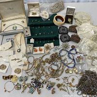 Overall assortment of costume jewelry items on table