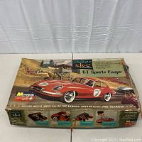 Closed box with vintage illustration of Jaguar XK-E GT Sports Coupe