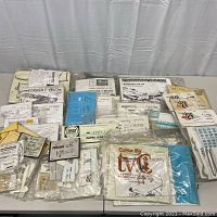 Wide shot of assorted vacform and injection model aircraft kits in sealed plastic bags on table