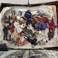 Top-down view of box containing various loose figures and parts