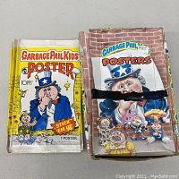 Top view showing individual full poster pack and original box with multiple packs inside.