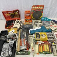Overview of all items in the lot including soldering kit, drill bits, reciprocating saw, hammers, wire brush, cutting disc, and others