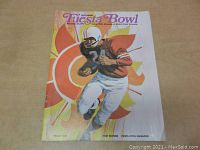 Front cover of the 1971 First Annual Fiesta Bowl program showing football player artwork and title text.