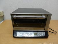 Front view of Cuisinart toaster oven showing stainless steel and digital control panel.