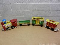Full set of four Fisher-Price Little People Circus Train cars lined up in order, showing all sides of the train.