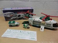 Full front view of the helicopter, emergency vehicle, motorcycle police, instructions, and box on table