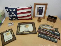 Lot of Bass Pro Shops picture frames, rustic decor including fishing themed wooden sign, small wooden holder, and American flag pillow.