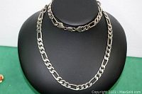 Front view of men's thick silver-tone necklace displayed on black bust, showing full length and clasp