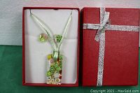 Full view of the Murano glass necklace with matching earrings in original red gift box with silver ribbon.