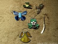 Overview of most stained glass pieces including blue butterfly, green frog, yellow angel, and hummingbird, along with the thin butterfly bookmark.