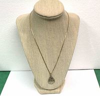 Full view of 10K gold two-tone teardrop pendant necklace on display bust