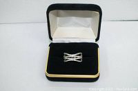 Sterling silver ring in black jewelry box, providing overall visual of the item and presentation.