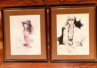 Photo showing both framed Sara Moon prints side by side on a wooden surface, highlighting overall condition and framing.