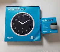 Box of Amazon Echo Wall Clock and Echo Dot speaker shown together