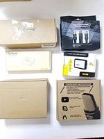 Boxed audio equipment with branded packaging for microphones, converter, and amplifier