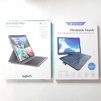 Both Logitech Slim Folio Pro and Typecase Flexbook Touch keyboard cases in their retail packaging.