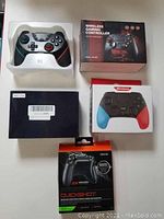 Overall photo showing all 5 controllers including boxed and unboxed items