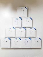 Ten boxed i12 true wireless stereo earphone sets arranged in a pyramid.