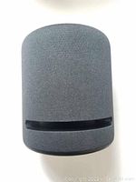 Front view of Echo Studio showing fabric mesh panel and top slot