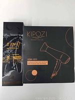 Packaging boxes for the straightener brush and KIPOZI hair dryer showing product branding and model XDM-1633