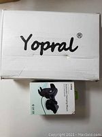 Boxes of Yopral pizza bag and iOttie phone holder showing brands and packaging