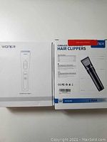 Two Woner hair clipper boxes, one labeled HC818B and the other HC827B.