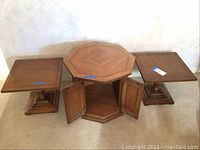 Image showing the octagon cabinet in center with doors closed, flanked by two square side tables on each side.