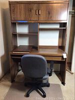 Front view of veneer wood grain computer desk with open shelving, cabinet, desk chair in front