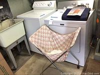 Overview showing Maytag top-load washer and front-load dryer side by side with laundry sink to left