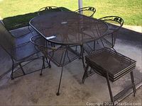 Full set with table, chairs, bench and side tables arranged on patio