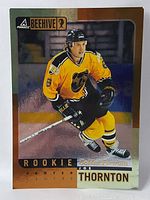Front side of the 1998 Joe Thornton Beehive rookie hockey card featuring him in yellow Bruins jersey, skating with stick.