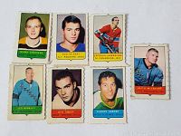 Seven 1969-70 O-Pee-Chee Mini hockey cards including Gerry Cheevers, Rod Gilbert, Jacques Laperriere, Keith McCreary, Les Binkley, Ken Hodge, Claude Larose.