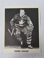 Front of the hockey card showing Eddie Shack in Toronto Maple Leafs uniform, skating pose.
