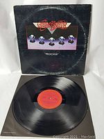 Aerosmith Rocks vinyl LP with cover and record visible showing wear.