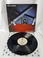 Vinyl LP record laid out with cover, showing label and surface condition