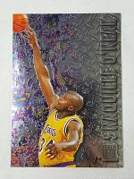 Front of 1996 Fleer Metal Shaquille O'Neal card showing player in Lakers jersey with embossed metallic background and title.