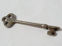 Side view of antique metal skeleton key showing overall length and shaft details