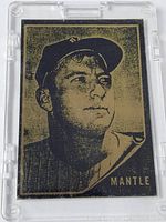 Front view of the Mickey Mantle brass metal baseball card showing the black printed image and name.