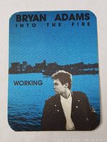 Front side of Bryan Adams Into The Fire tour worker pass with image and text